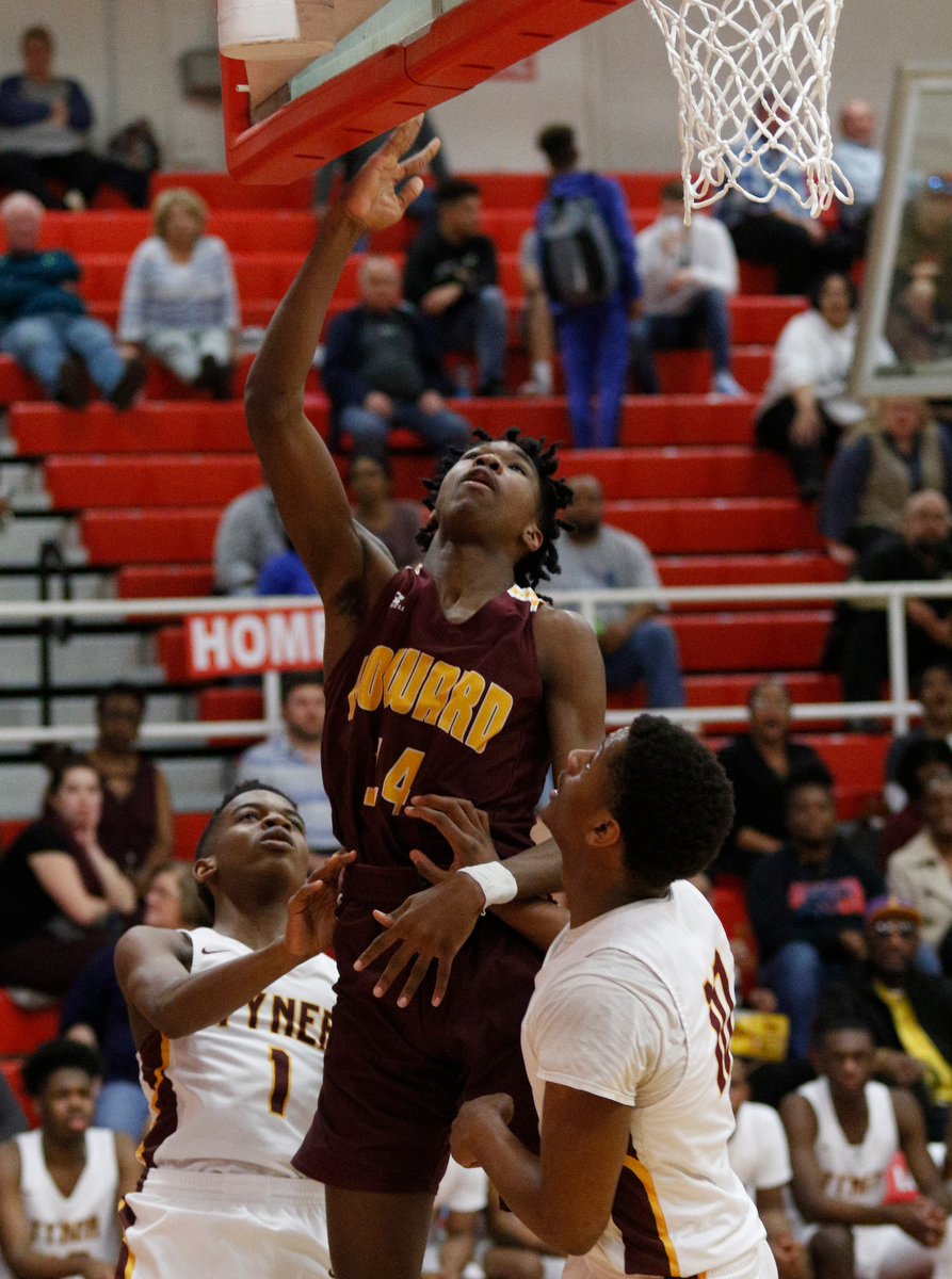 Howard's Kerrick Thorne, center, shoots between Tyner's Trenton Gresham, left, and Soloman Bridgeman during their Region 3-AA basketball tournament semifinal game at Loudon High School on Tuesday, Feb. 26, 2019, in Loudon, Tenn. Brainerd won 70-65.