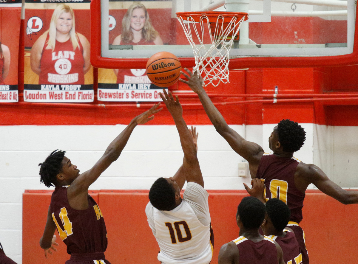 Tyner's Soloman Bridgeman, center, shoots between Howard's Meechie Bowens, right, and Kerrick Thorne during their Region 3-AA basketball tournament semifinal game at Loudon High School on Tuesday, Feb. 26, 2019, in Loudon, Tenn. Brainerd won 70-65.