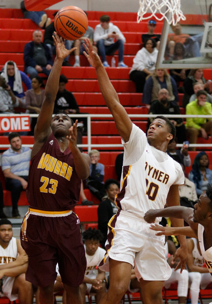 Howard's Calvin James (23) shoots around Tyner's Solomon Bridgeman during their Region 3-AA basketball tournament semifinal game at Loudon High School on Tuesday, Feb. 26, 2019, in Loudon, Tenn. Brainerd won 70-65.