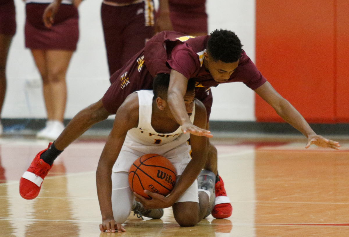Howard's Dicorius Knight falls atop Tyner's Trenton Gresham during their Region 3-AA basketball tournament semifinal game at Loudon High School on Tuesday, Feb. 26, 2019, in Loudon, Tenn. Brainerd won 70-65.