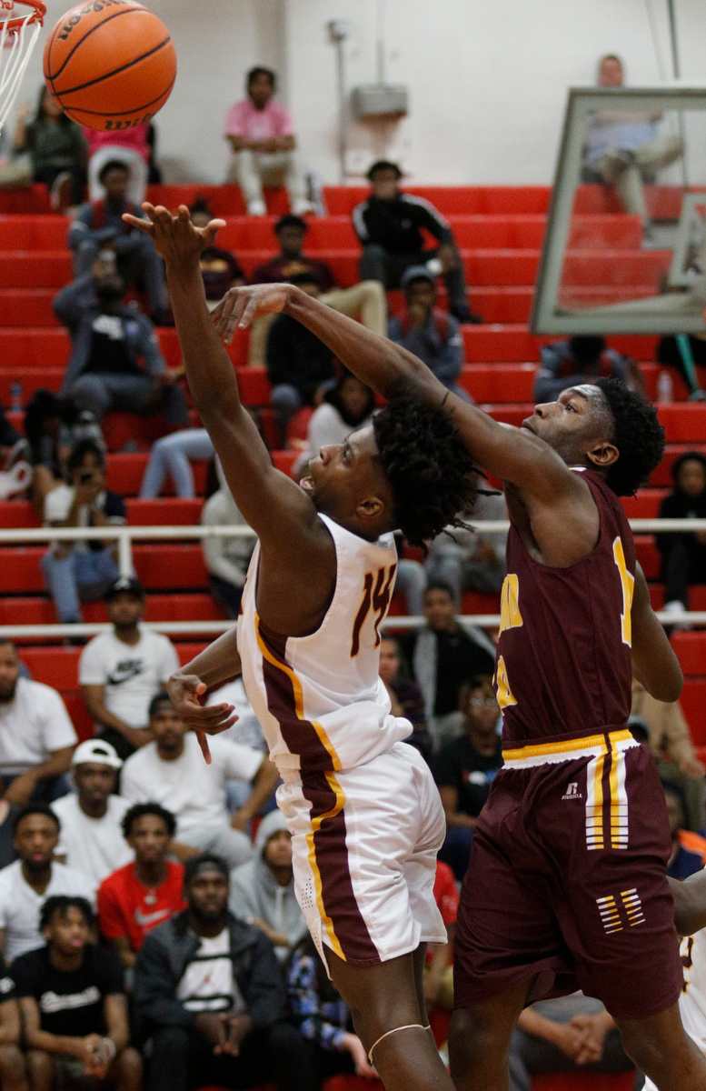 Tyner's Keilan Holloway, left, shoots ahead of Howard's Meechie Bowens during their Region 3-AA basketball tournament semifinal game at Loudon High School on Tuesday, Feb. 26, 2019, in Loudon, Tenn. Brainerd won 70-65.