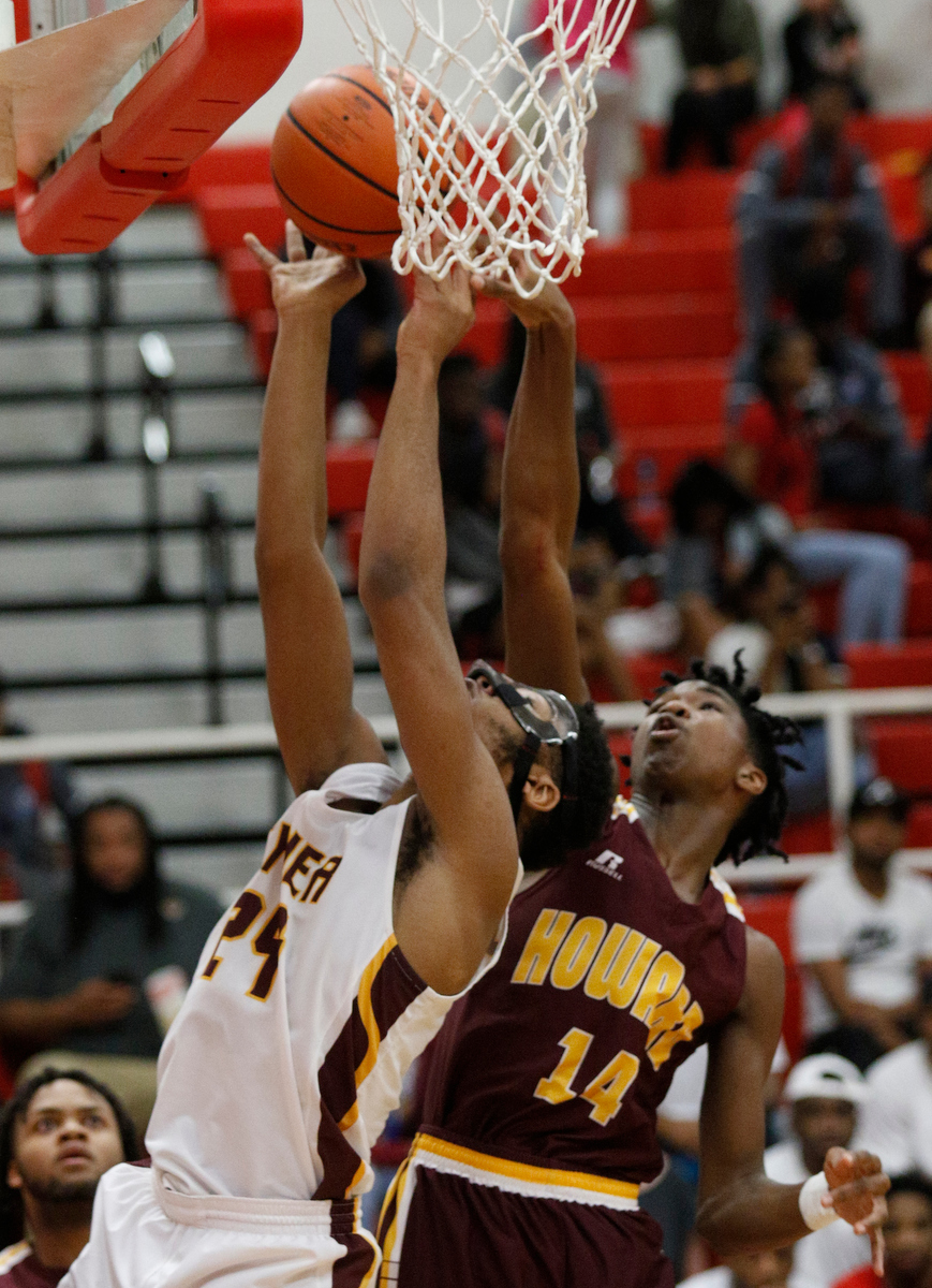 Tyner's Kobe Smith, left, shoots around Howard's Kerrick Thorne during their Region 3-AA basketball tournament semifinal game at Loudon High School on Tuesday, Feb. 26, 2019, in Loudon, Tenn. Brainerd won 70-65.