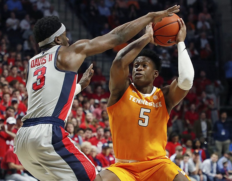 Tennessee guard Admiral Schofield (5) is tightly covered by Ole Miss guard Terence Davis during the first half of Wednesday night's game in Oxford, Miss.