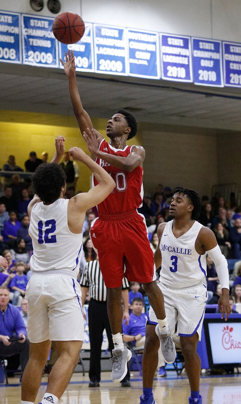 Baylor's Beyuan Hendricks shoots between McCallie's Anthony Watkins (12) and Shannon Walker on Feb. 8 during their rivalry matchup at McCallie. Hendricks has starred this season for the Red Raiders, who are among the final four teams in the Division II-AA state tournament.
