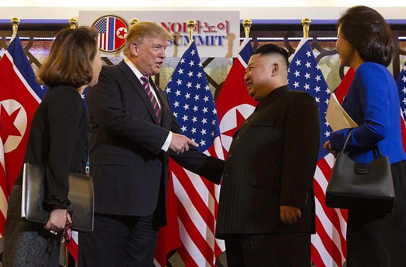 President Donald Trump meets North Korean leader Kim Jong Un, Wednesday, Feb. 27, 2019, in Hanoi, as interpreters look on. (AP Photo/ Evan Vucci)

