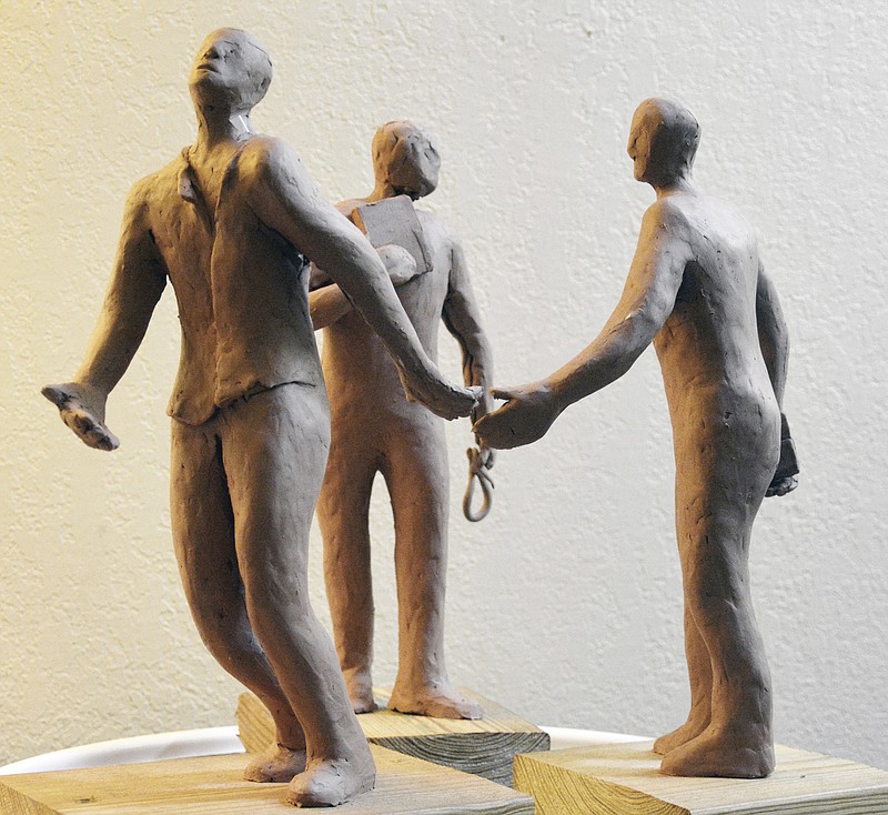 Models of the three central figures in the Ed Johnson Memorial by sculptor Jerome Meadows are depicted.