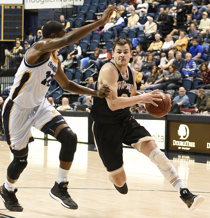 Wofford's Fletcher Magee drives to the basket while guarded by UTC's James Lewis Jr. during Thursday night's SoCon matchup at McKenzie Arena. Magee scored 18 points as the No. 24 Terriers rolled past the Mocs, 80-54, to improve to 17-0 in league games this season.