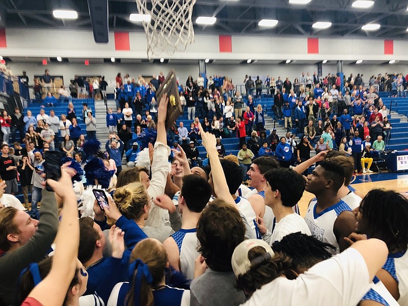 The Cleveland boys' basketball team and its fans celebrate the Region 3-AAA championship victory over visiting East Hamilton on Thursday night. The Blue Raiders have won 20 straight games and are a win away from the state tournament.