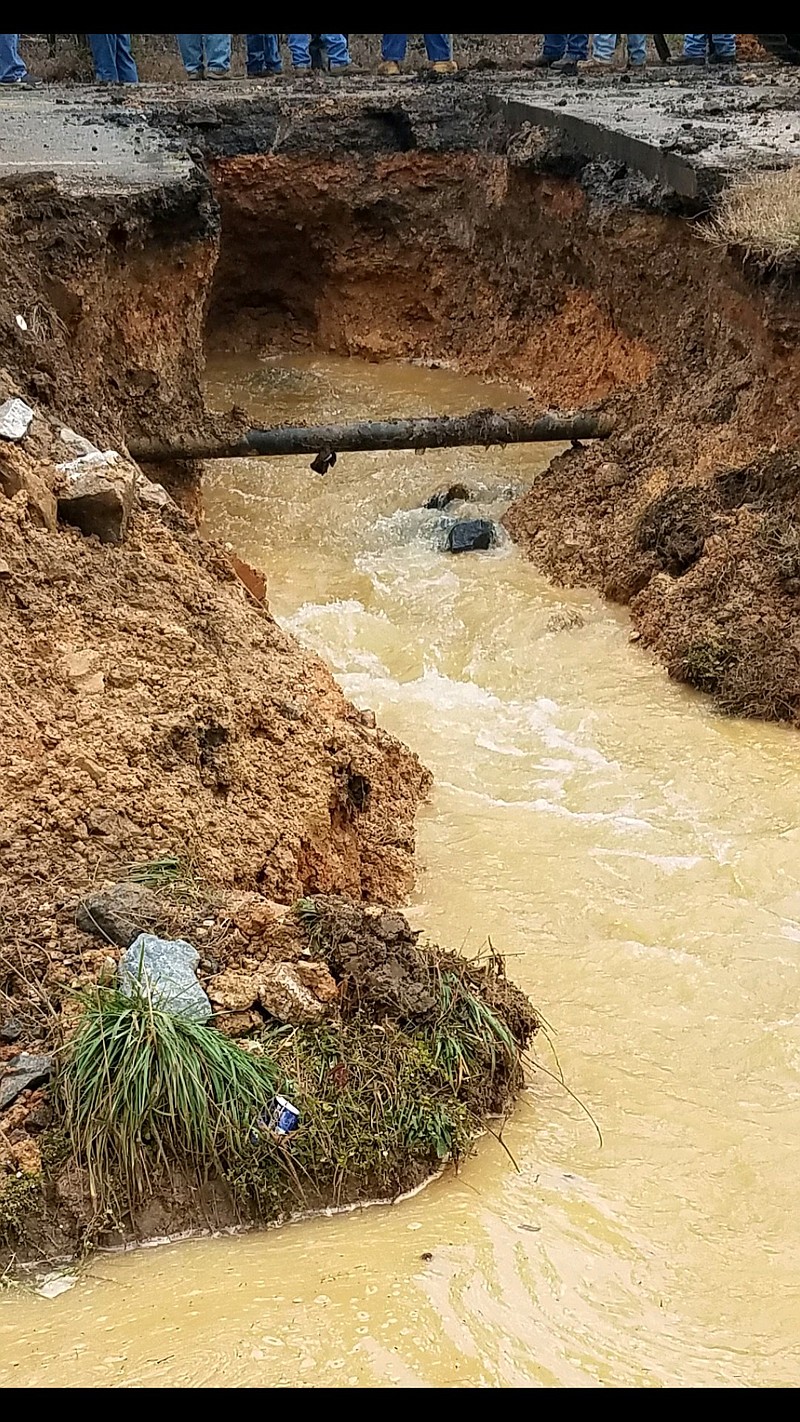 A stormwater drain under Highway 48 in Chattooga County, Ga., washed out Tuesday night causing the road to collapse. Georgia Department of Transportation crews are working to repair the damage but ongoing rain could complicate the work.