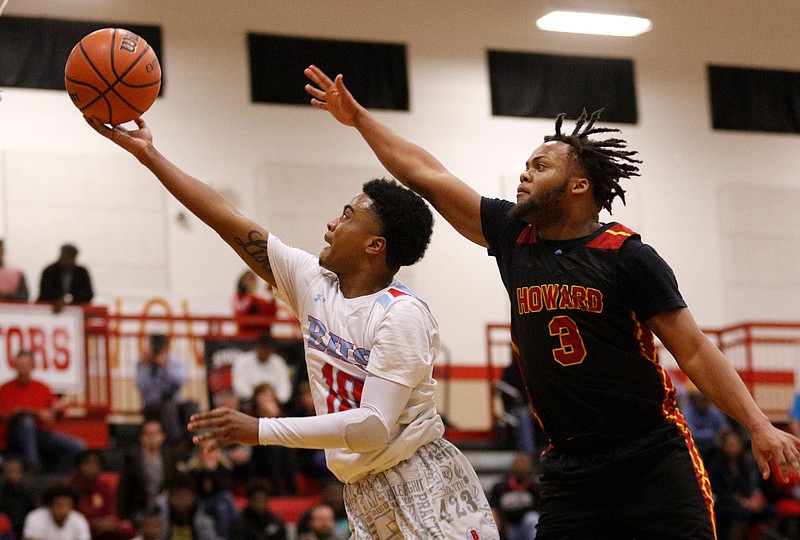 Brainerd's Kevin Halfacre Jr. drives to the basket ahead of Howard's Marquez Williams during the Region 3-AA championship game Thursday night on Signal Mountain.