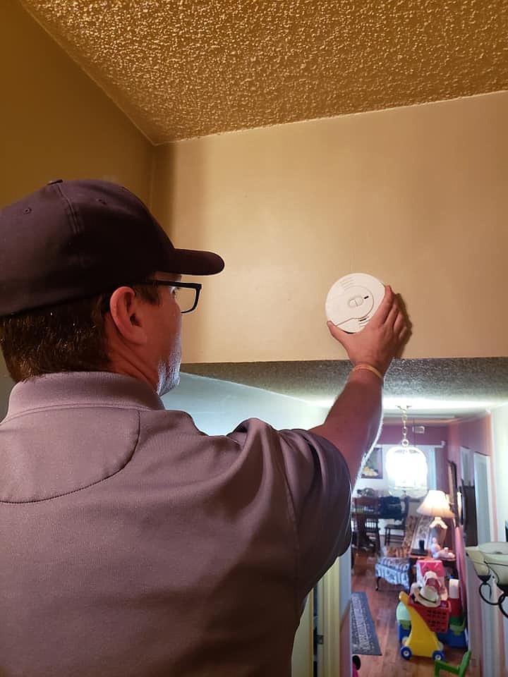 Fire personnel install a smoke alarm in a resident's home. Any county resident in need of a smoke alarm can receive one for free by contacting Walker County Fire & Rescue at 706-539-1255. (Contributed photo)