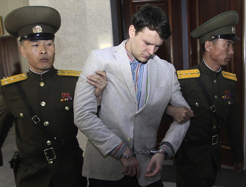 In this March 16, 2016, file photo, American student Otto Warmbier, center, is escorted at the Supreme Court in Pyongyang, North Korea. President Donald Trump says he doesn't think North Korean leader Kim Jong Un was involved in the mistreatment of American college student Otto Warmbier, who died after being detained in the North. Trump says of Kim: "He tells me that he didn't know about it, and I will take him at his word." The Ohio native was sentenced to 15 years of hard labor in North Korea on suspicion of stealing a propaganda poster. Warmbier died in 2017, shortly after being sent home in a coma. (AP Photo/Jon Chol Jin, File)