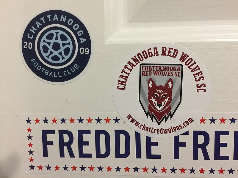 The stickers affixed to the door of Mark Kennedy's 12-year-old son illustrate the tension in the Kennedy household as their loyalties are torn between Chattanooga Football Club and the Red Wolves.