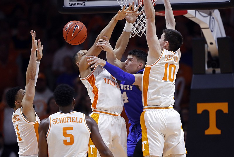 Kentucky forward Nick Richards, in blue, passes under pressure from, from left, Tennessee's Lamonte Turner, Admiral Schofield, Grant Williams and John Fulkerson during Saturday's top-10 matchup in Knoxville. Tennessee won 71-52.