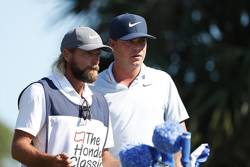 Former Baylor School and University of Georgia golf standout Keith Mitchell, right, talks with his caddie, Pete Persolija, during the third round of the Honda Classic on Saturday in Palm Beach Gardens, Fla.