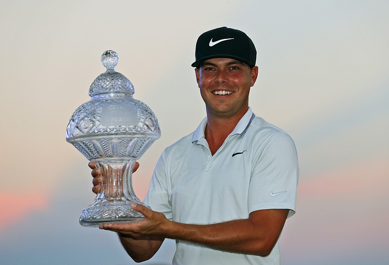 Keith Mitchell holds up his trophy after winning the Honda Classic on Sunday in Palm Beach Gardens, Fla.