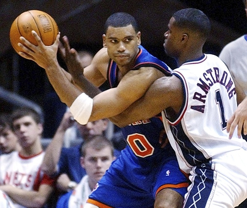 The New York Knicks' Allan Houston, left, protects the ball as he is pressured by the New Jersey Nets' Brandon Armstrong during an NBA game in October 2003 in East Rutherford, N.J. Houston played at the University of Tennessee before going on to a 12-year career in the NBA.