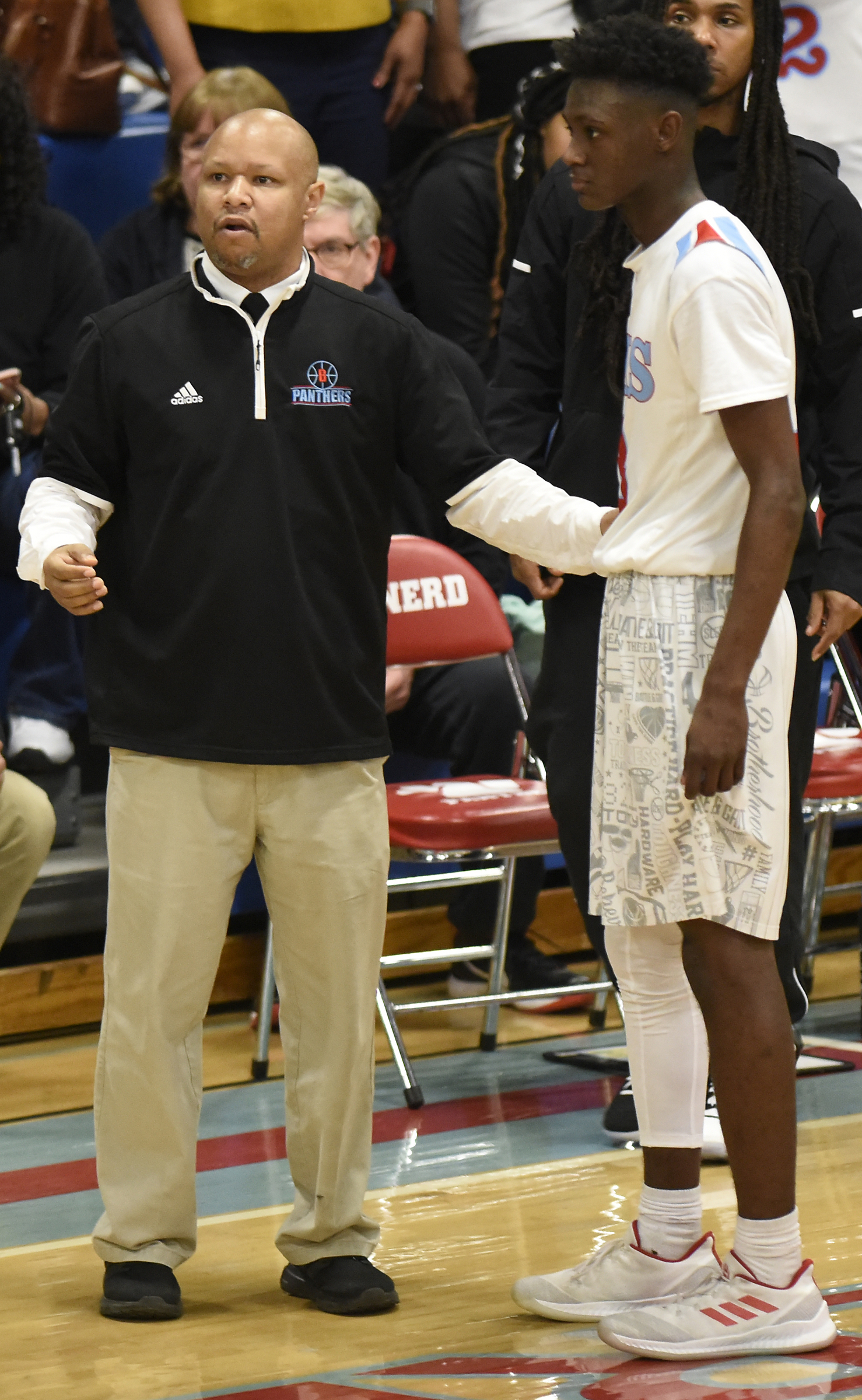 Brainerd head coach Levar Brown confers with Trey Owten (3) during a injury timeout. The Brainerd High Panthers hosted the York Institute Dragons in a Class AA TSSAA sectional game on March 4, 2019.