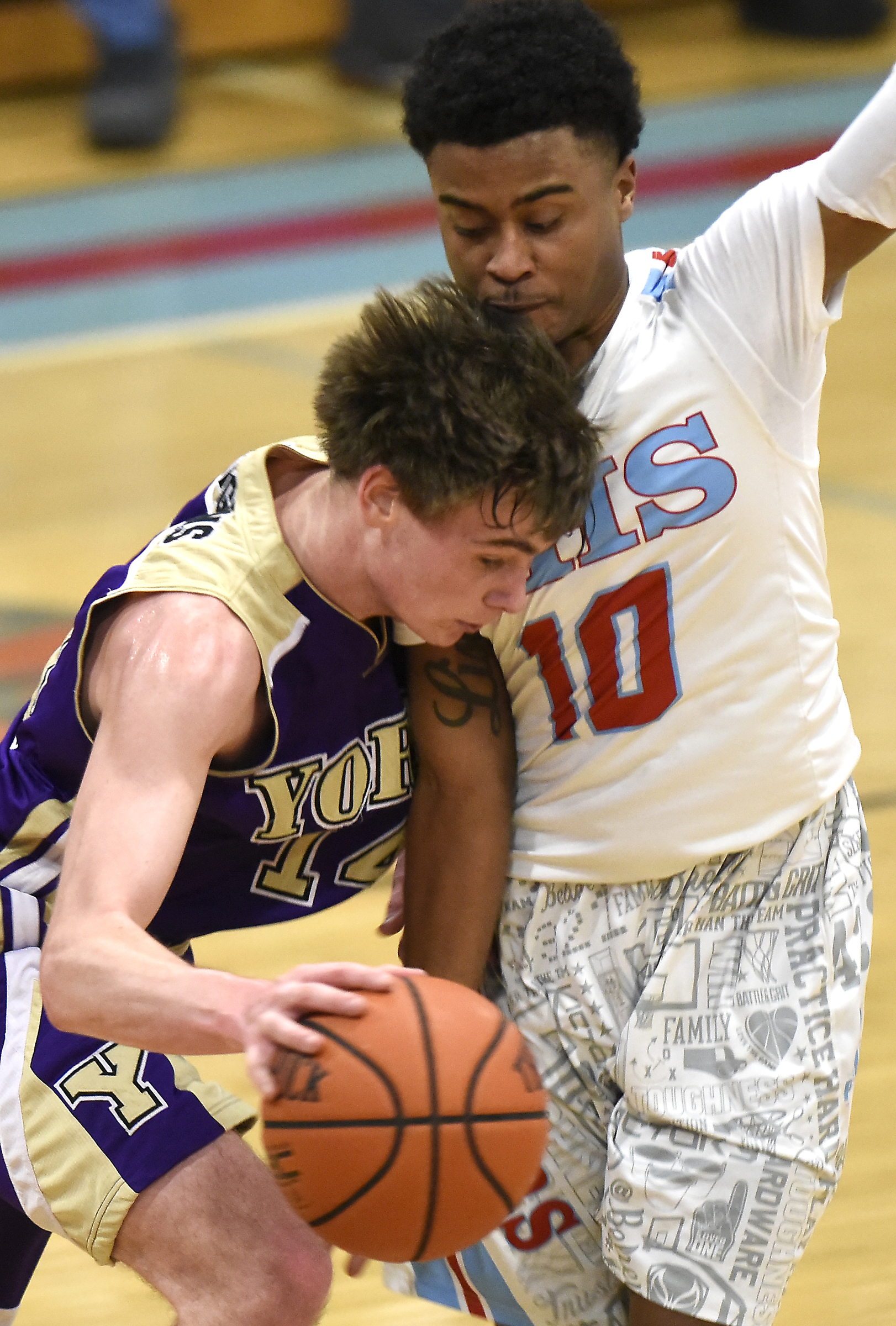 York's Case Moody (14) tries to dribble through the aggresive defense of Kevin Halfacre Jr. (10). The Brainerd High Panthers hosted the York Institute Dragons in a Class AA TSSAA sectional game on March 4, 2019.