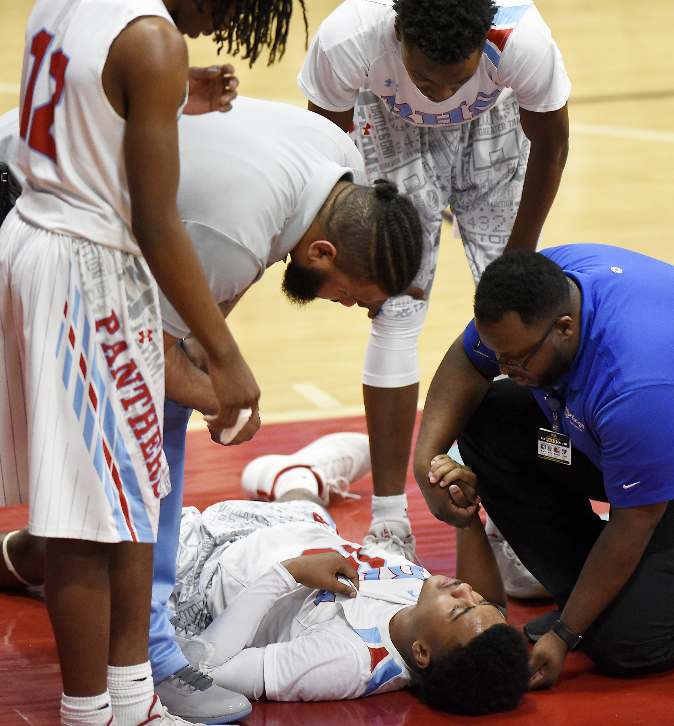 A injured Kevin Halfacre Jr. (10) is seen to by a trainer as his teammates show concern. The Brainerd High Panthers hosted the York Institute Dragons in a Class AA TSSAA sectional game on March 4, 2019.