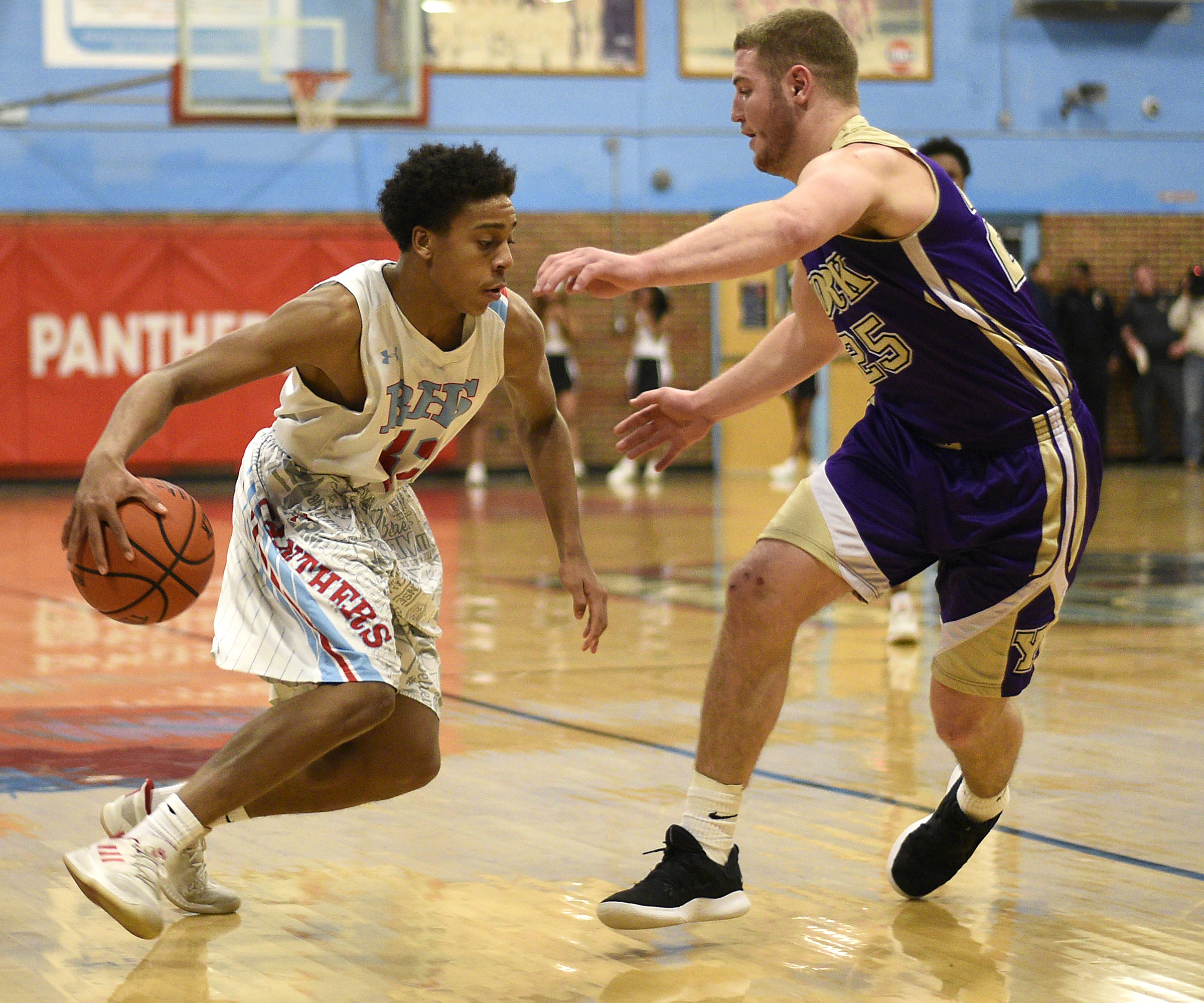 Brainerd's Cameron Evans (32) dribbles behind his back as he moves against York's Landrick Leffew (25). The Brainerd High Panthers hosted the York Institute Dragons in a Class AA TSSAA sectional game on March 4, 2019.