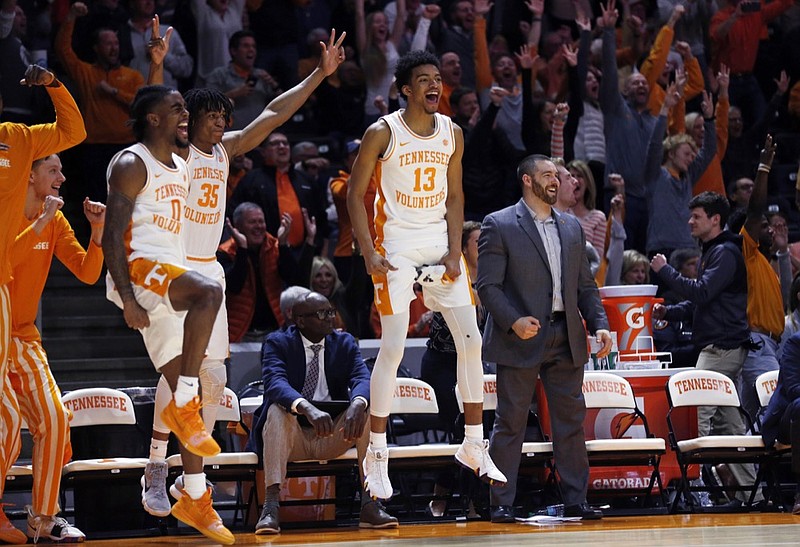 Tennessee guard Jalen Johnson (13), forward Yves Pons (35) and guard Jordan Bone (0) react to a 3-point shot by guard Brad Woodson during the second half of the team's NCAA college basketball game against Mississippi State on Tuesday, March 5, 2019, in Knoxville, Tenn. Tennessee won 71-54. (AP Photo/Wade Payne)

