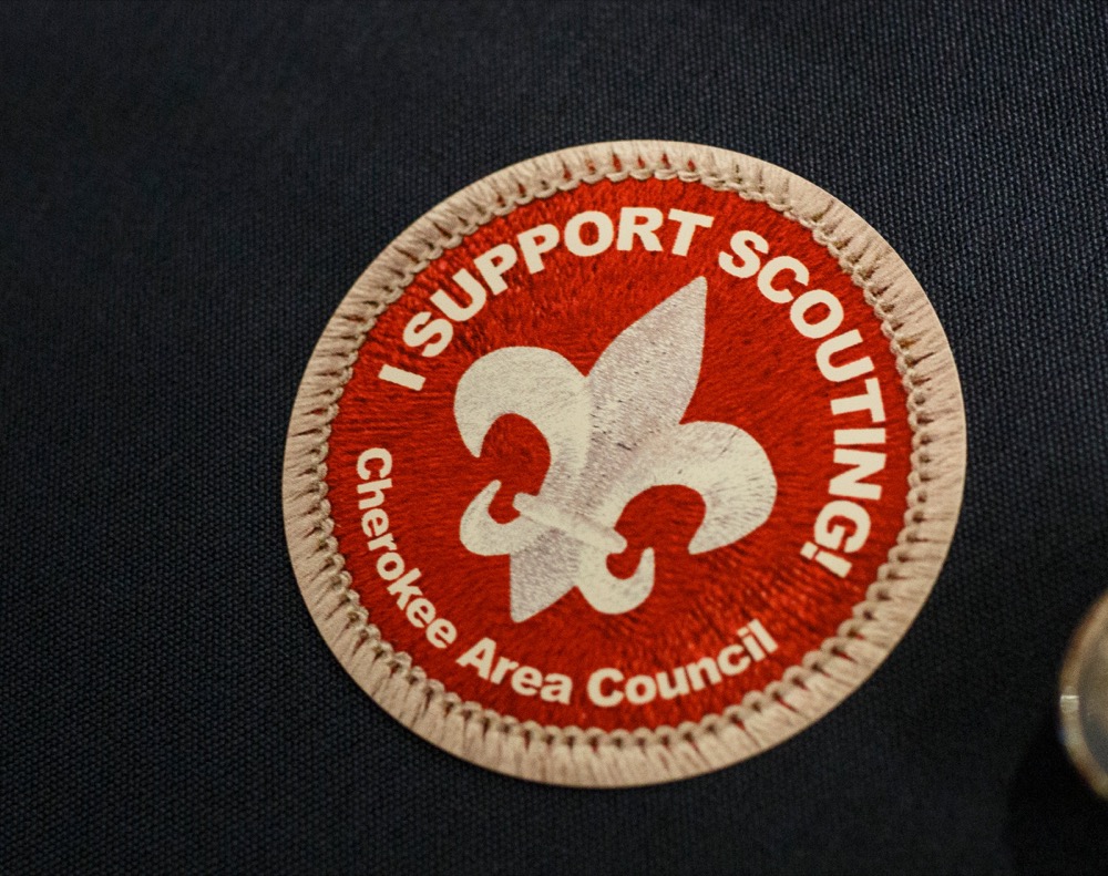 A scouting support sticker is seen on a table at the Chattanooga Convention Center on Wednesday, March 6, 2019, in Chattanooga, Tenn. Captain Richard Phillips, whose story of capture by pirates in the Guardafui Channel is the subject of the film Captain Phillips starring Tom Hanks, was the speaker at the Cherokee Area Council of the Boy Scouts of America's Friends of Scouting Luncheon.