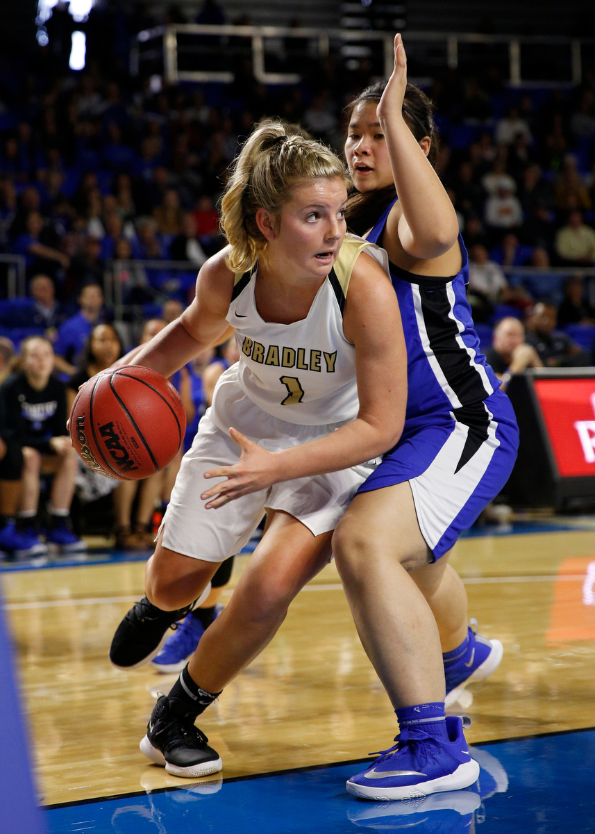 Bradley Central shooting guard Kaleigh Hughes (1) dribbles around Lebanon point guard Anne Marie Heidebreicht (20) during the Bearettes' TSSAA Class AAA girls basketball quarterfinal against the Lady Blue Devils at Middle Tennessee State University's Murphy Center on Thursday, March 7, 2019, in Murfreesboro, Tenn.