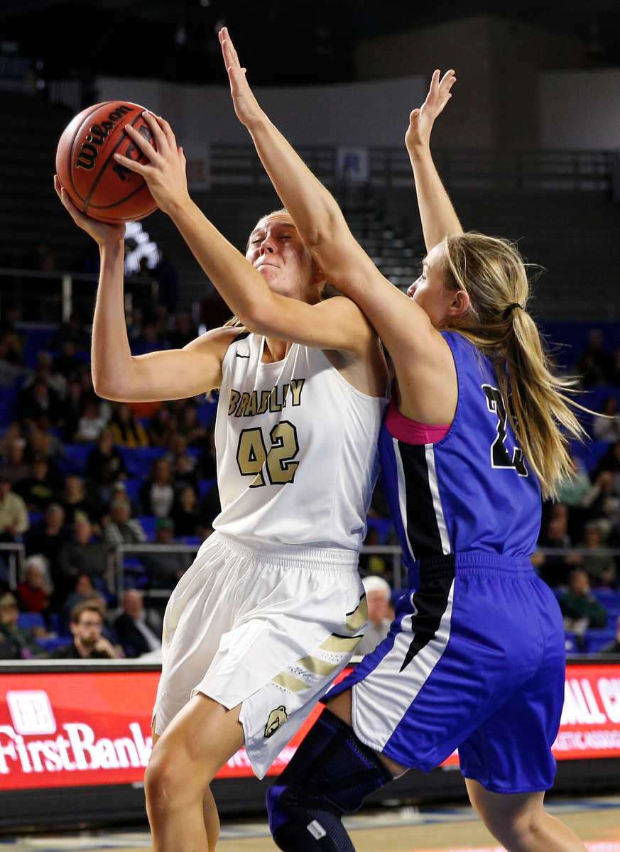 Bradley Central power forward Anna Walker (42) shoots around Lebanon wing Lindsey Freeman (23) during the Bearettes' TSSAA Class AAA girls basketball quarterfinal against the Lady Blue Devils at Middle Tennessee State University's Murphy Center on Thursday, March 7, 2019, in Murfreesboro, Tenn.