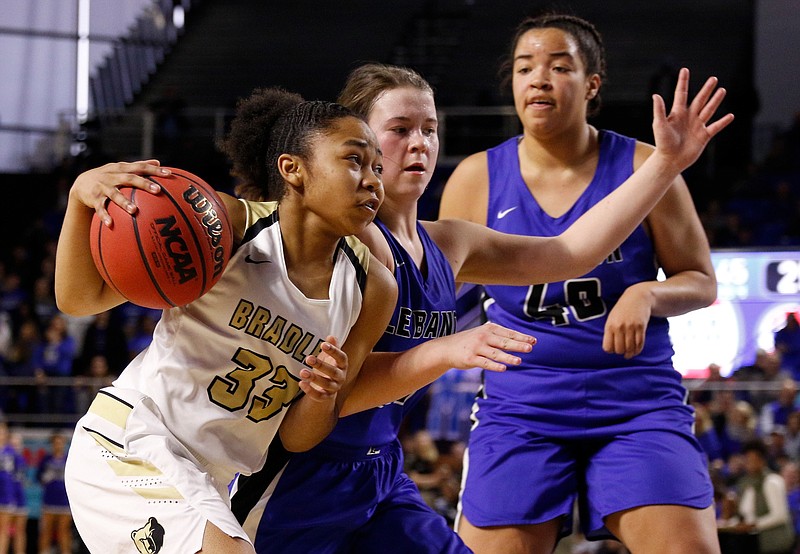 Bradley Central point guard Jamaryn Blair dribbles around Lebanon's Addie Porter, middle, and Christaney Brookshire during their teams' TSSAA Class AAA state quarterfinal Thursday at Middle Tennessee State University's Murphy Center in Murfreesboro.