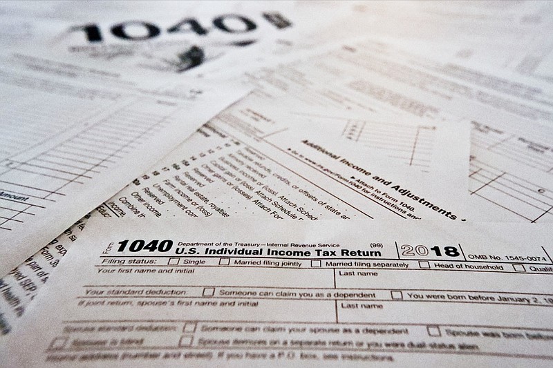 FILE - This Feb. 13, 2019 file photo shows multiple forms printed from the Internal Revenue Service web page that are used for 2018 U.S. federal tax returns in Zelienople, Pa. It's tough to know all the answers at tax time, particularly in a year with massive tax law changes. Sometimes people need help, but where should they turn? There are several options. (AP Photo/Keith Srakocic)

