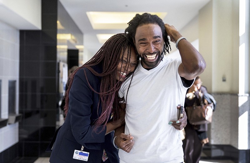 Sheila Banks and Clinton Jones, Jr., brother of Corey Jones, walking down the hall from the courtroom Thursday, March 7, 2019 after Nouman Raja was found guilty of shooting and killing stranded motorist Corey Jones, in West Palm Beach, Fla. Raja, 41, faces a mandatory minimum of 25 years at sentencing April 26, and could spend his life in prison for the death of Corey Jones. (Greg Lovett/Palm Beach Post via AP, Pool)


