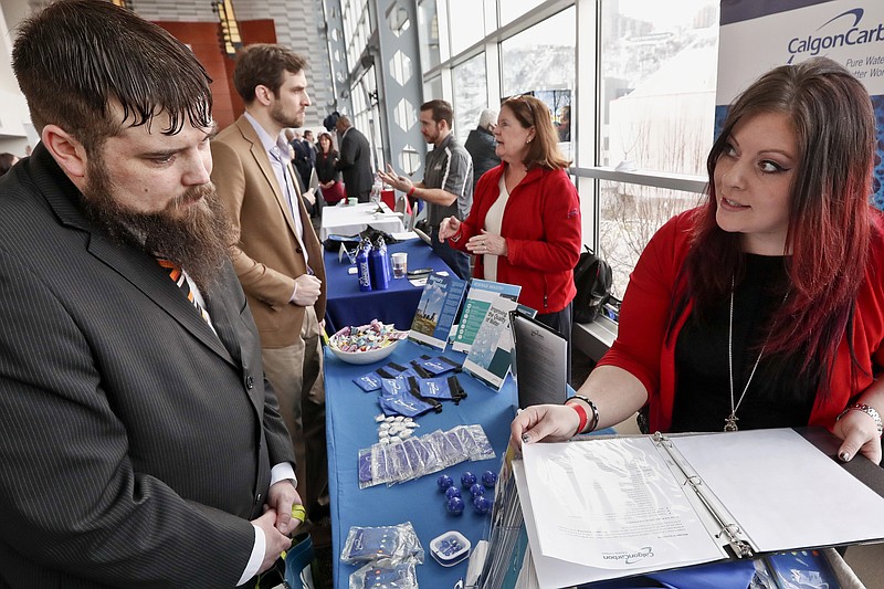 In this Thursday, March 7, 2019, photo visitors to the Pittsburgh veterans job fair meet with recruiters at Heinz Field in Pittsburgh. On Friday, March 8, the U.S. government issues the February jobs report, which will reveal the latest unemployment rate and number of jobs U.S. employers added. (AP Photo/Keith Srakocic)