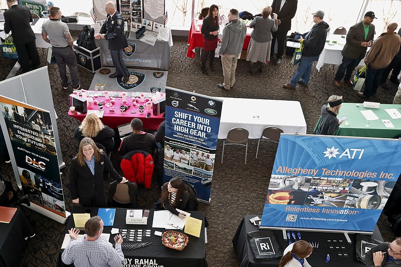 In this Thursday, March 7, 2019, photo visitors to the Pittsburgh veterans job fair meet with recruiters at Heinz Field in Pittsburgh. On Friday, March 8, the U.S. government issues the February jobs report, which will reveal the latest unemployment rate and number of jobs U.S. employers added. (AP Photo/Keith Srakocic)