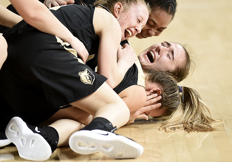 Bradley Central's Hannah Lombard, center, is mobbed by teammates, from top, Jamaryn Blair, Cambree Mayo and Anna Walker after Lombard made the winning 3-pointer in the final seconds of the TSSAA Class AAA girls' basketball state title game Saturday at Middle Tennessee State University's Murphy Center in Murfreesboro. The Bearettes beat Houston 46-44 to win the program's sixth state title and first since 1976.