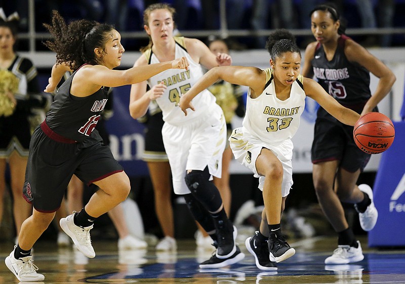 Bradley Central's Jamaryn Blair heads downcourt with Brianna Dunbar, left, and the rest of the Oak Ridge defense behind during a TSSAA Class AAA state semifinal Friday in Murfreesboro.