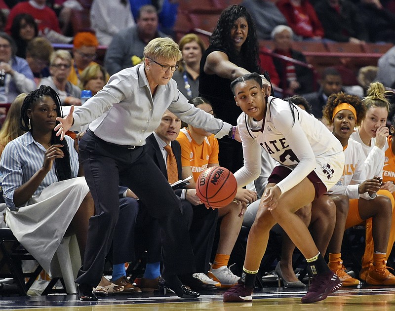 Mississippi State's Bre'Amber Scott recovers a loose ball in front of Tennessee's bench and coach Holly Warlick during the first half of an SEC women's basketball tournament quarterfinal on Friday in Greenville, S.C. Mississippi State won 83-68.
