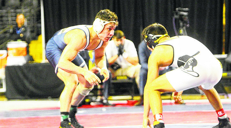 UTC 141-pound junior Chris Debien, left, wrestles Apalachian State's Irvin Enriquez in the finals of the SoCon tournament Sunday in Boone, N.C. Debien won 12-7 to secure an NCAA bid.