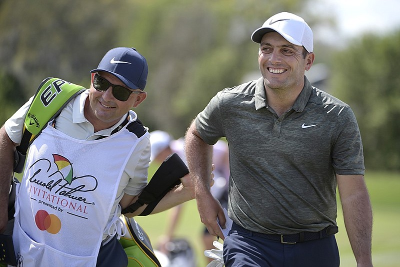 Francesco Molinari, right, leaves the first green after making a putt for birdie during the final round of the Arnold Palmer Invitational on Sunday at Bay Hill in Orlando, Fla.
