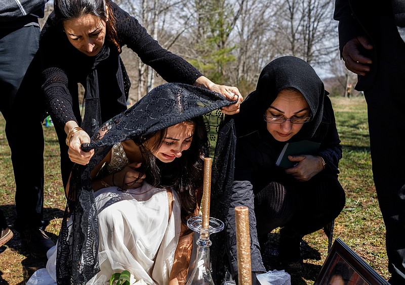 Staff photo by Doug Strickland / Sona Baluch, left, places a black veil on the head of Sara Baluch as she mourns with Michelle Sharifi, right. Sara's fiancé, Mohammad Sharifi, was shot and killed in Chattanooga before their planned wedding.