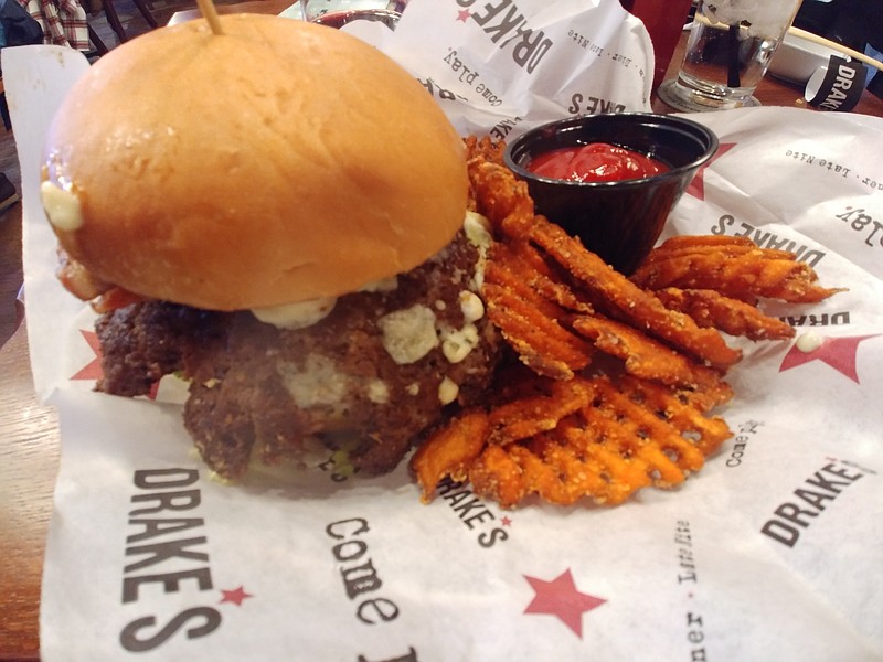 The Big Blue Burger is seasoned with Cajun spice and topped with blue cheese crumbles, dressing and bacon. All come with the option of tater tots, Drake's fries, waffled sweet potato fries, broccoli florets or coleslaw.