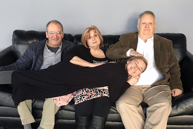 Kasey Torbett, cast in the title role of Sylvia the dog, finds a resting place on the laps of director Trevis Orr and cast members Susan Guentensberger and Jeff Guentensberger, from left. / Ocoee Theatre contributed photo