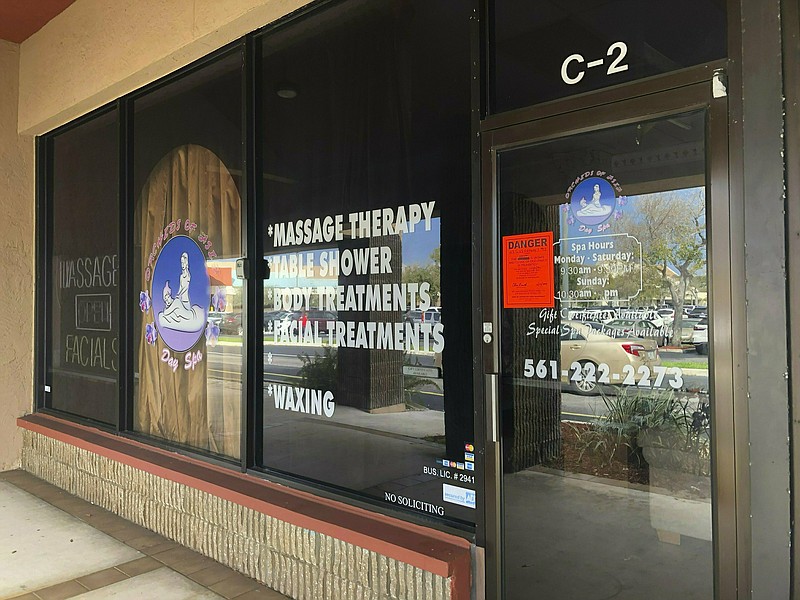 In this Feb. 19, 2019 file photo, a sign is posted outside Orchids of Asia Day Spa in Jupiter, Fla. (Hannah Morse/Palm Beach Post via AP, File)