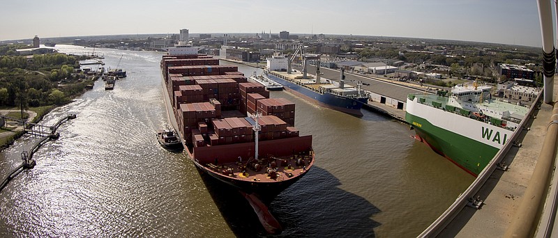 In this photo provided by the Georgia Port Authority, the ZIM Tianjin sails up-river past Savannah's historic downtown on the way to the Georgia Ports Authority Port of Savannah, Wednesday, March 18, 2015, in Savannah, Ga. The 10,000-TEU vessel is the largest container ship to call on the Port of Savannah. (AP Photo/Georgia Port Authority, Stephen Morton)