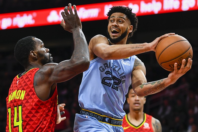 Memphis Grizzlies guard Tyler Dorsey looks to pass while guarded by Atlanta Hawks center Dewayne Dedmon during the second half of Wednesday night's game in Atlanta. The Hawks won 132-111.