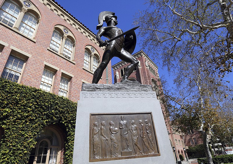 The University of Southern California in Los Angeles s one of many colleges and companies moving swiftly to distance themselves from employees swept up in a nationwide college admissions scheme, many charged with taking bribes and others from well-to-do and celebrity parents accused of angling to get their children into top schools. (AP Photo/Reed Saxon)