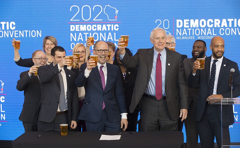 Democratic National Committee chairman Tom Perez (center) hoists a celebratory beer with Milwaukee Mayor Tom Barrett (right) and Milwaukee Bucks senior vice president Alex Lasry (left) following the official announcement that Milwaukee will host the 2020 Democratic National Convention on March 12 at Fiserv Forum in Milwaukee, Wisconsin. MARK HOFFMAN/MILWAUKEE JOURNAL SENTINEL