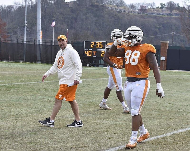 Tennessee head football coach Jeremy Pruitt works with redshirt sophomore defensive lineman Aubrey Solomon (98) during a drill at Wednesday's practice at Haslem Field.