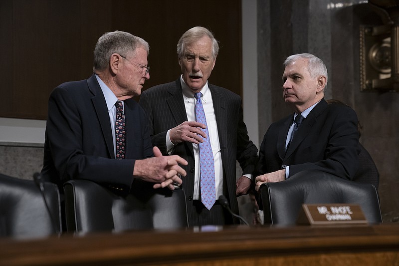 From left, Senate Armed Services Committee Chairman Jim Inhofe, R-Oklahoma, Sen. Angus King, I-Maine, and Ranking Member Jack Reed, D-Rhode Island, confer before a hearing on the Pentagon budget on Capitol Hill in Washington last Thursday. (AP Photo/J. Scott Applewhite)