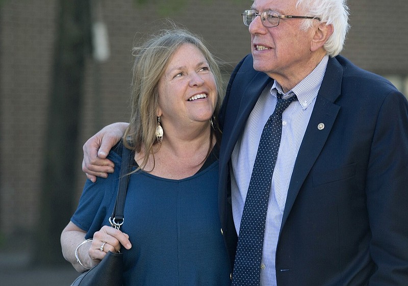 FILE - In this April 19, 2016, file photo, Democratic presidential candidate Sen. Bernie Sanders, I-Vt., and his wife Jane take a walk in State College, Pa. The Sanders Institute, a think tank founded by Democratic presidential contender Bernie Sanders' wife and son, has stopped accepting donations and plans to suspend all operations by the end of May. (AP Photo/Mary Altaffer, File)

